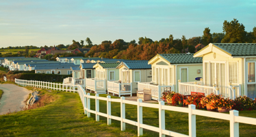 A row of caravans next to the beach. 