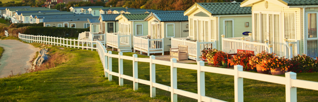 A row of caravans next to the beach. 